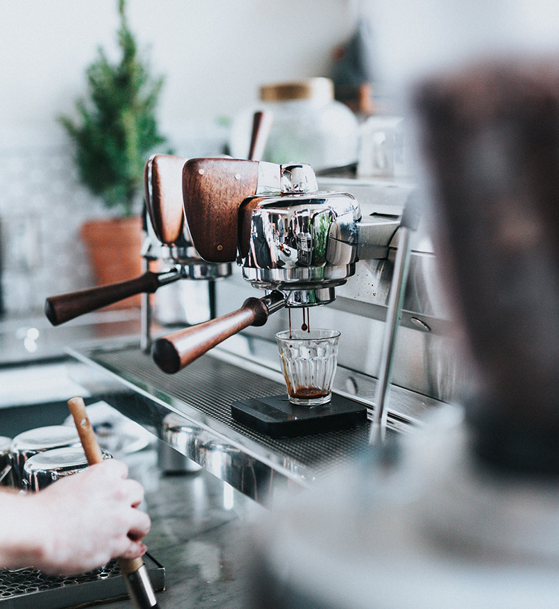 Coffee machine dispensing coffee in a cafe